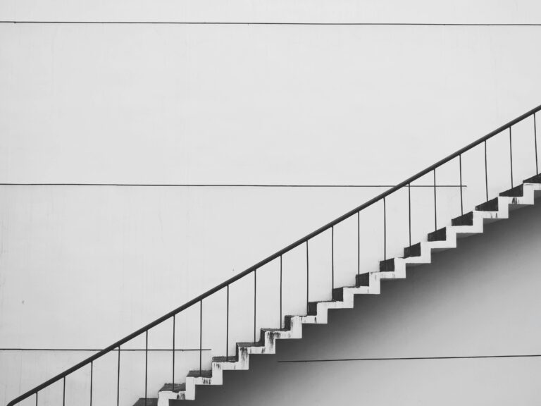 Minimalistic black and white staircase with sharp angles and clean lines, showcasing modern architecture.
